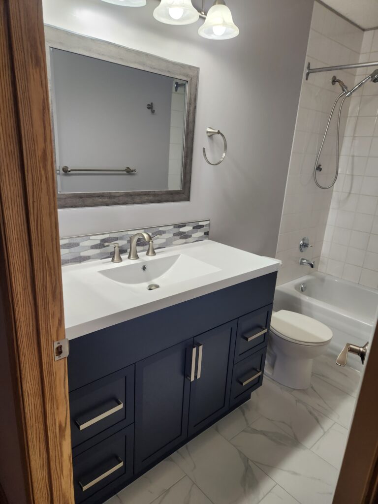 Modern bathroom with a double sink vanity and a bathtub.
