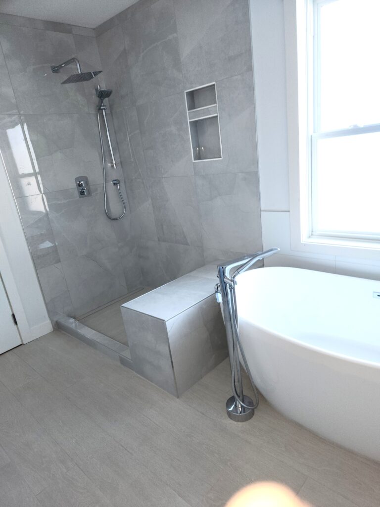 Modern bathroom with a freestanding tub and glass shower.