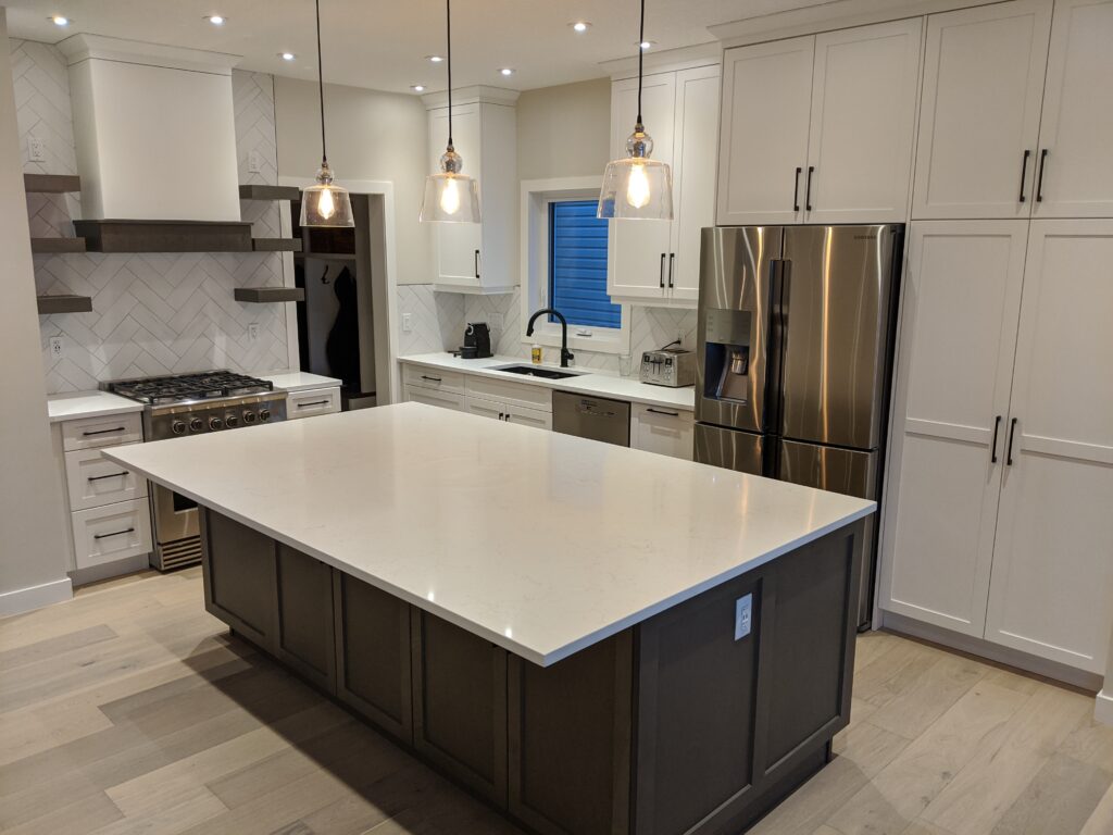Modern kitchen with island and stainless appliances.