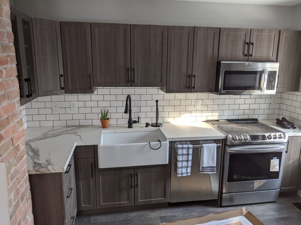 Modern kitchen with stainless steel appliances.