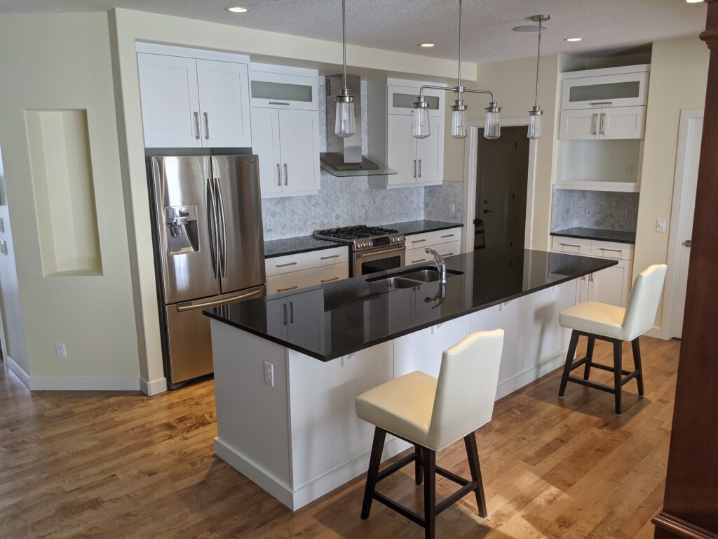 Modern kitchen with island and bar stools.