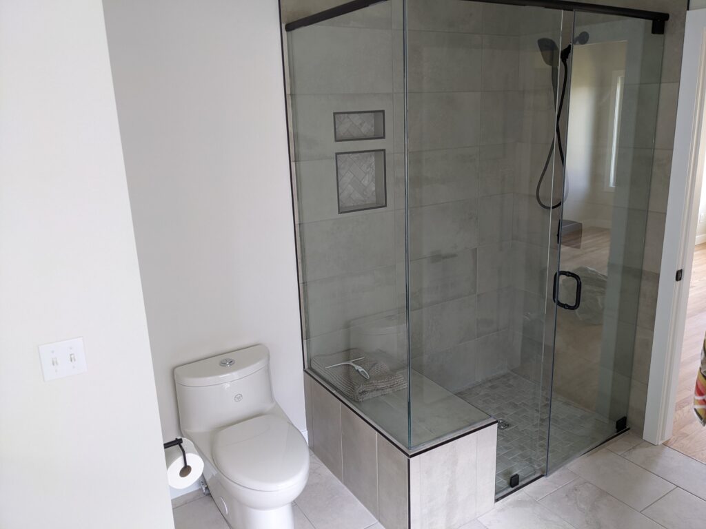 Modern bathroom with glass shower enclosure.