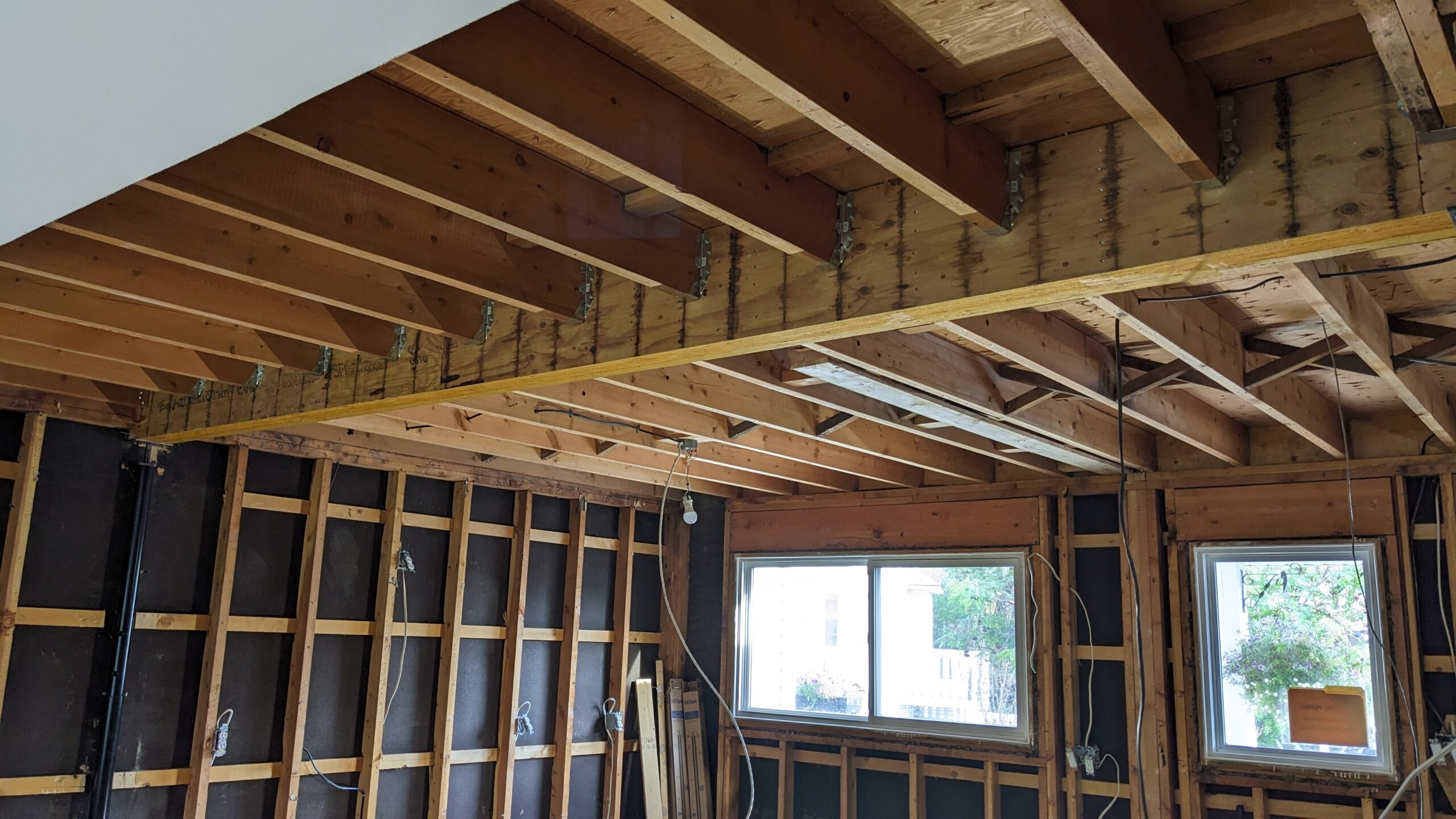 Exposed wooden beams in room under renovation.