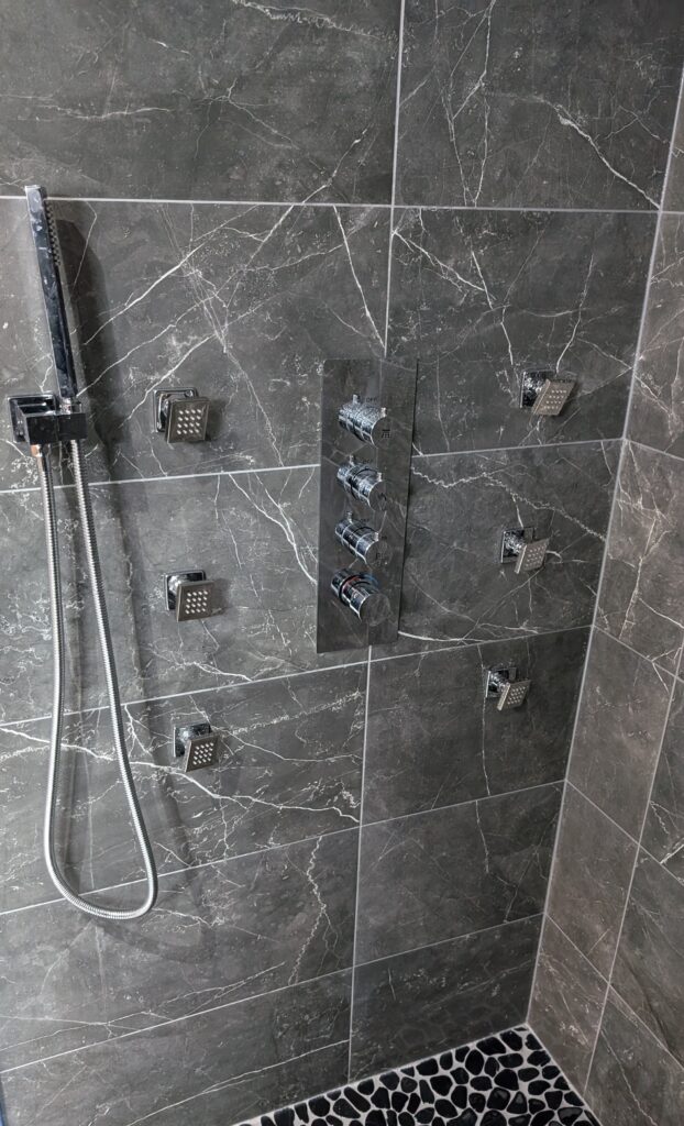 Modern shower with multiple spray heads.